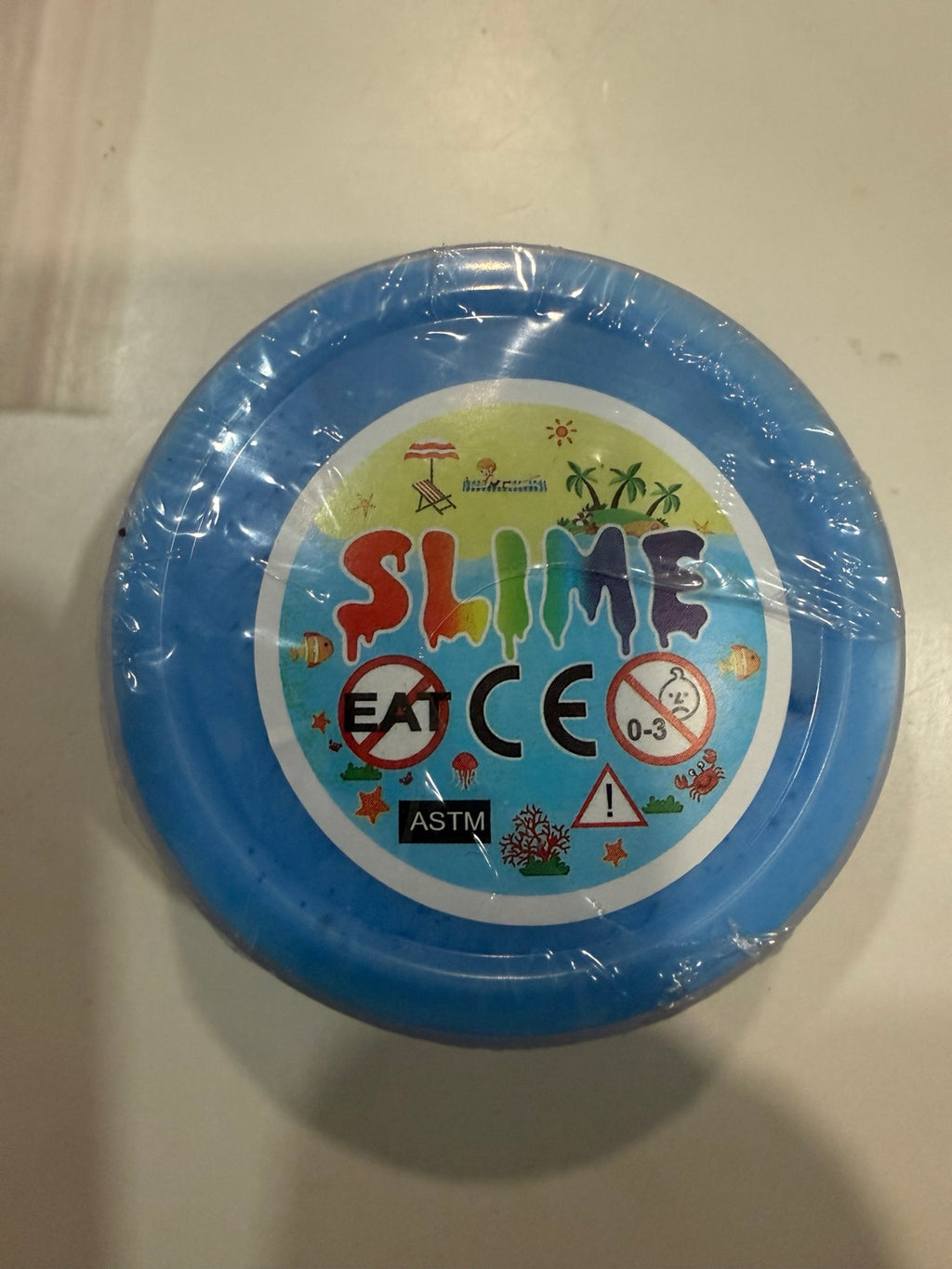 Blue 2 oz slime cup with product label