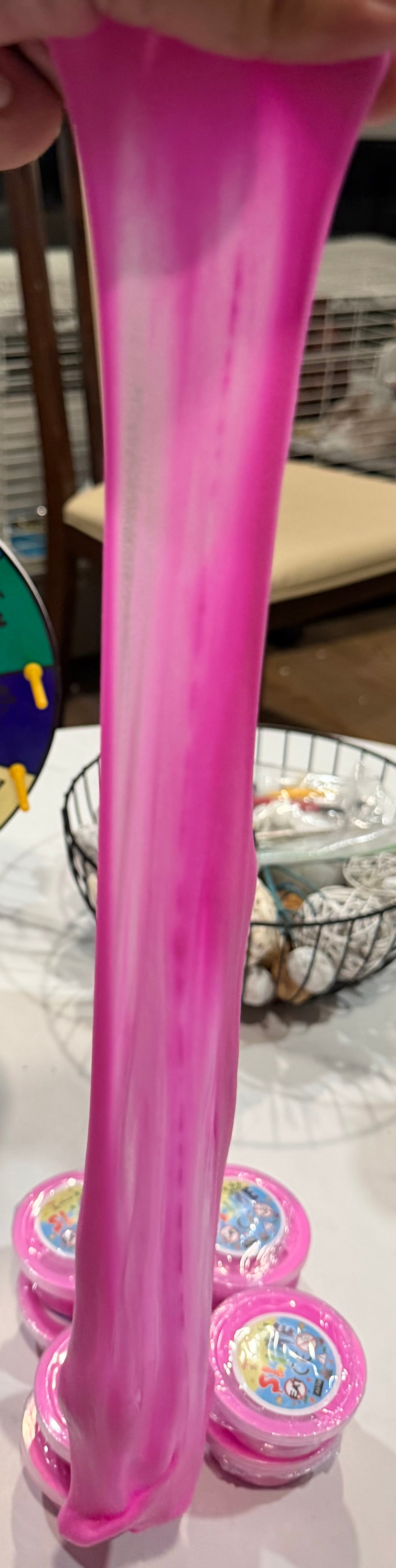 Pink slime stretched from a 2 oz slime cup