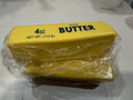 Yellow butter stick squishy toy wrapped in clear plastic