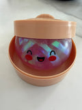 Glitter confetti mystery dumpling squishy in steamer container