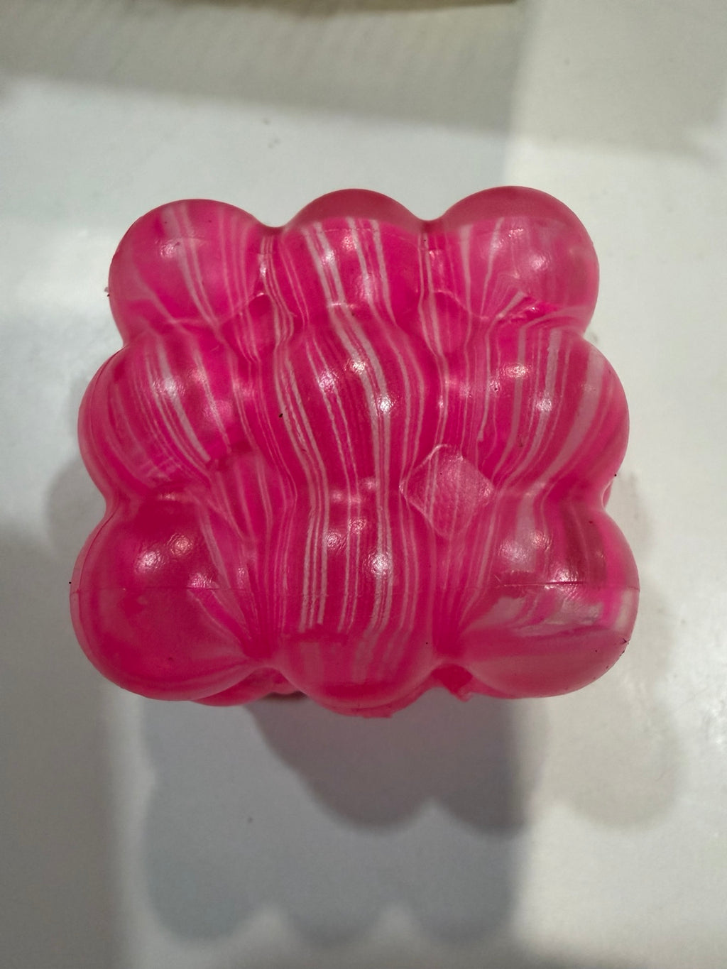 Pink marbled translucent bumpy cube squeeze toy
