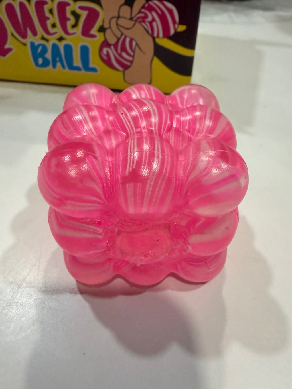Close-up of pink marbled bumpy cube sensory squeeze toy