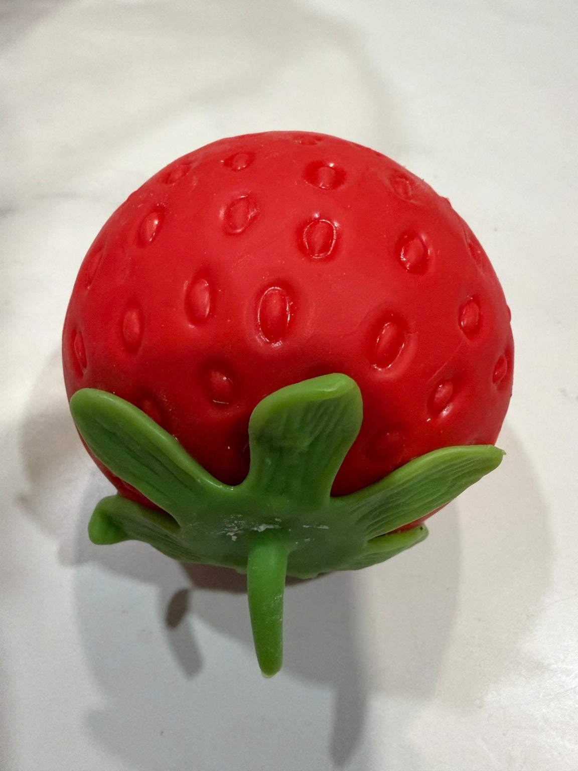 Red strawberry squishy with green leafy top